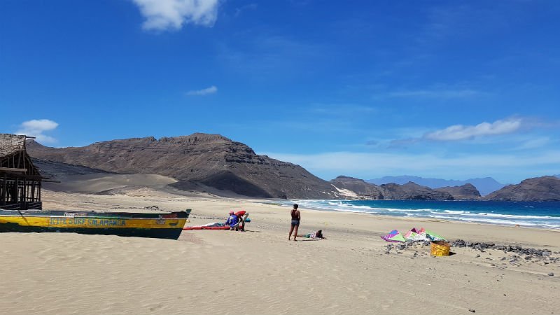 Surfing and fishing on a deserted beach